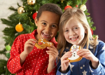 Two Young Children Eating Christmas Treats